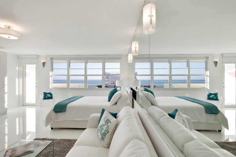 wide angle view of living room with mirrors and ocean view