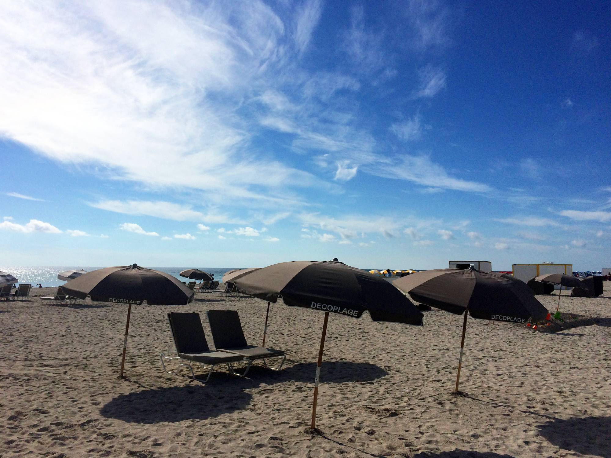beach with beach chairs and umbrellas