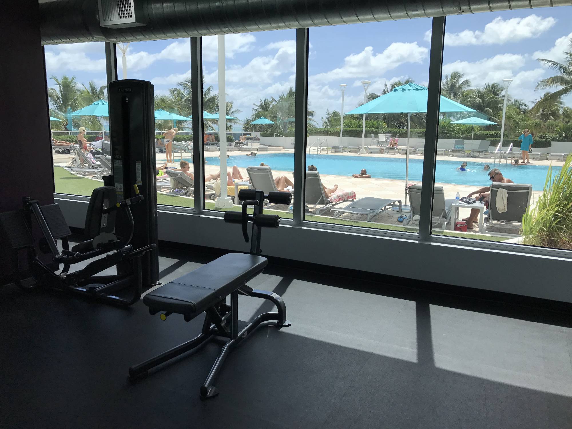 gym with pool and ocean view