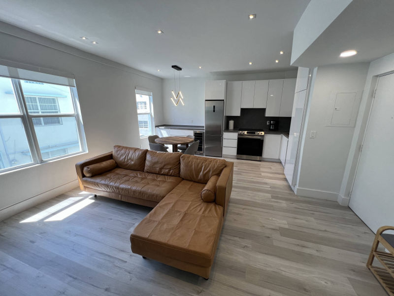 living room, dining corner and kitchen in background