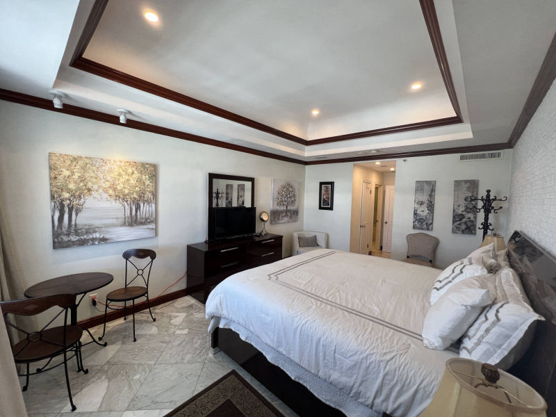  bedroom with bathroom door in the background