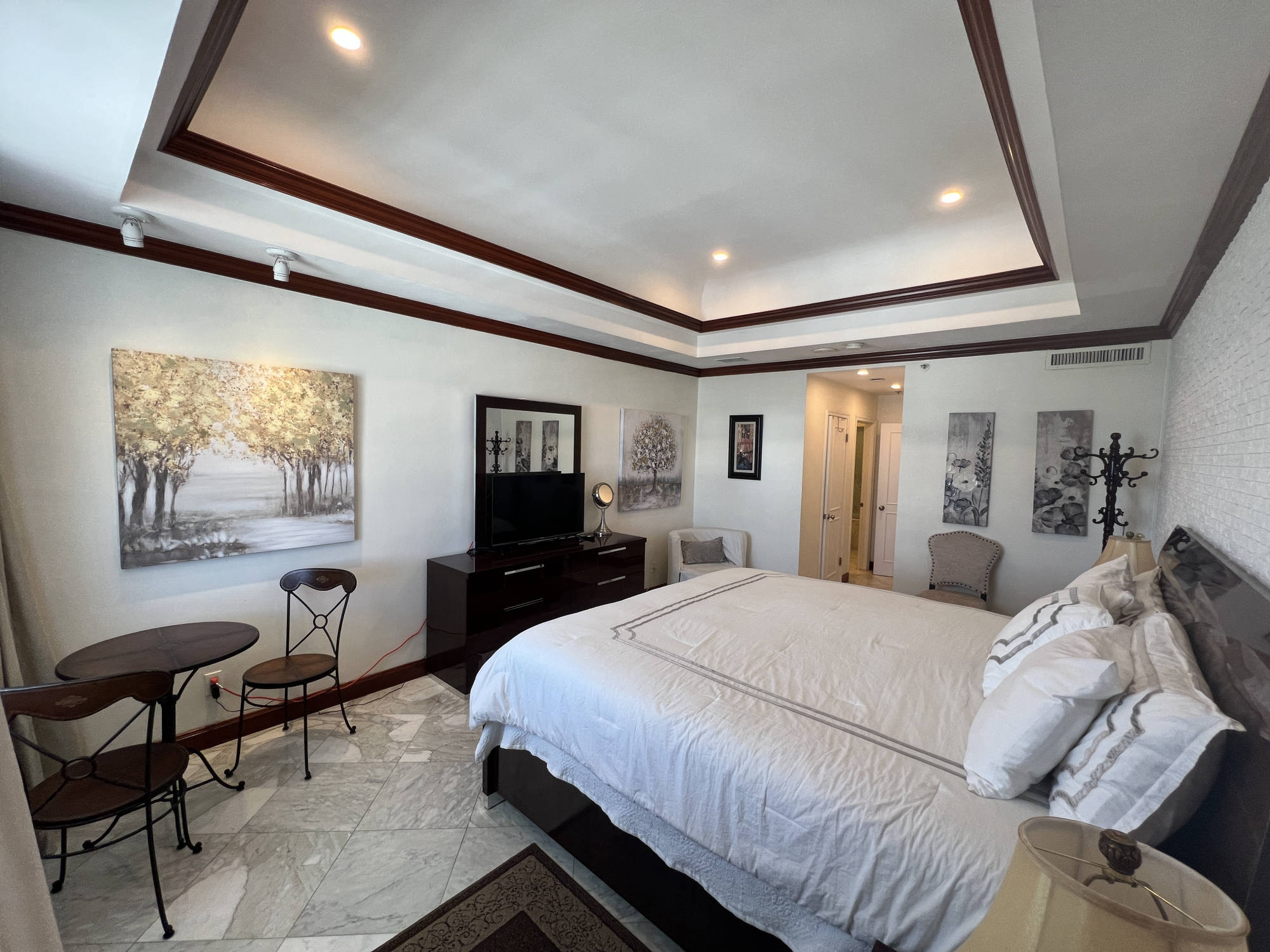  bedroom with bathroom door in the background