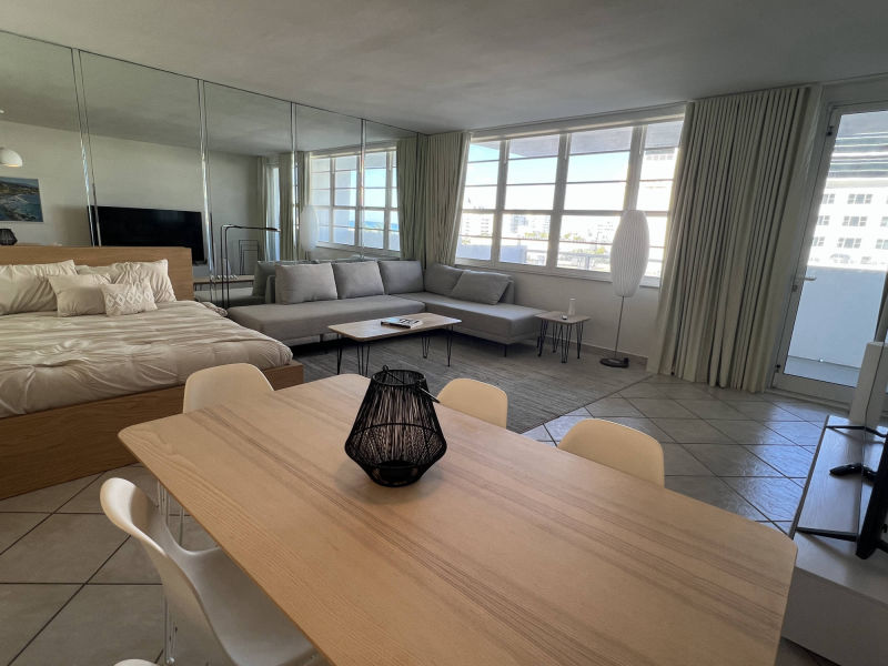 living room with bed and dining table